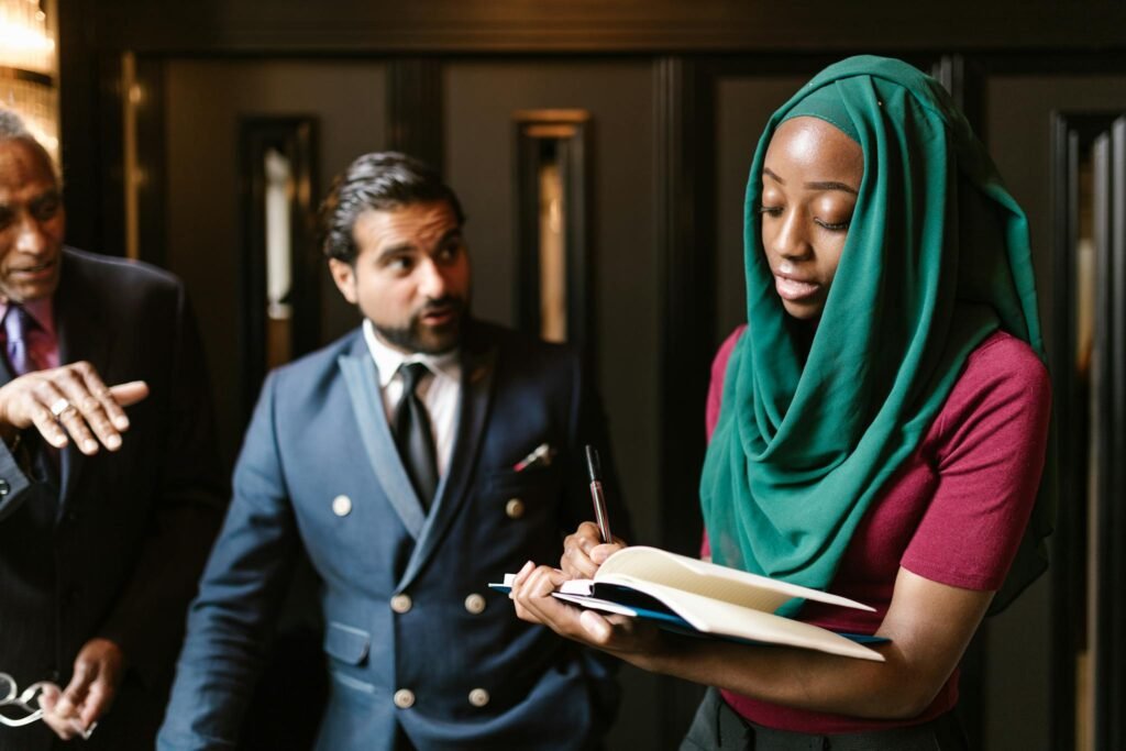 Diverse group of professionals engaged in a business meeting, focusing on collaboration and note-taking.